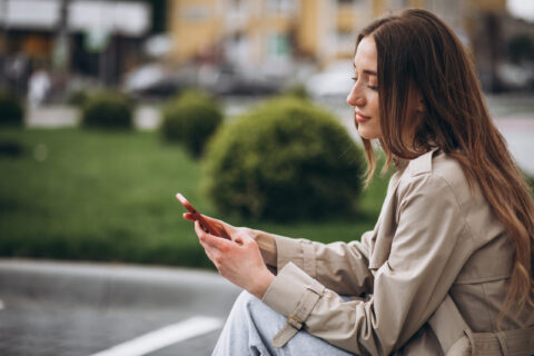 Woman using cellphone in park