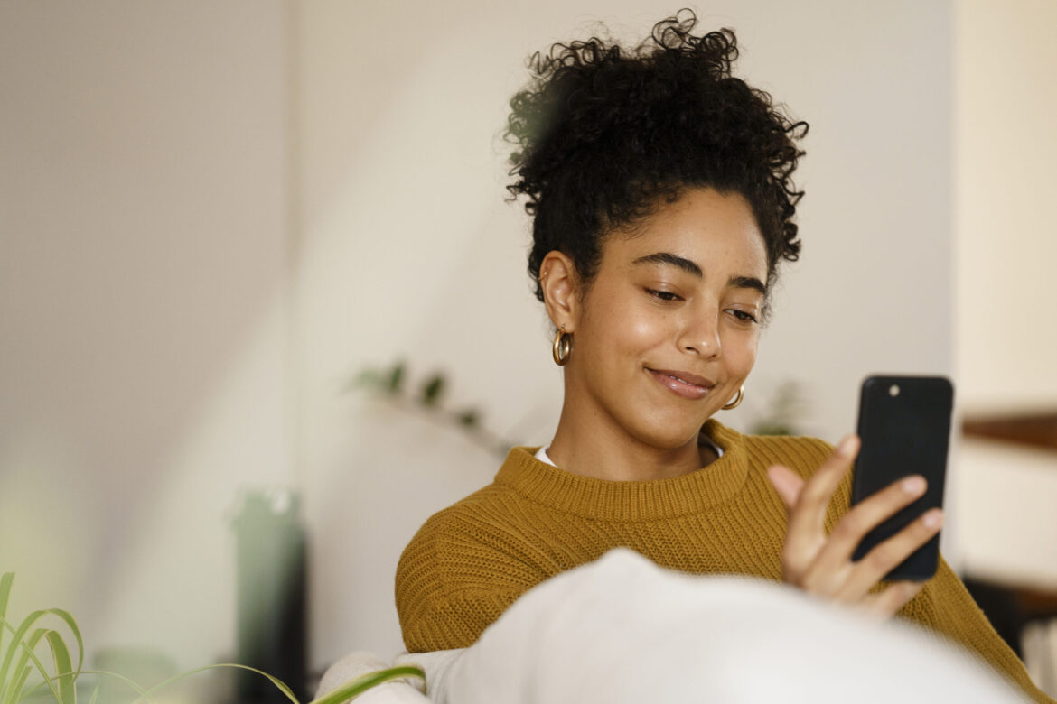 Woman smiling at smartphone