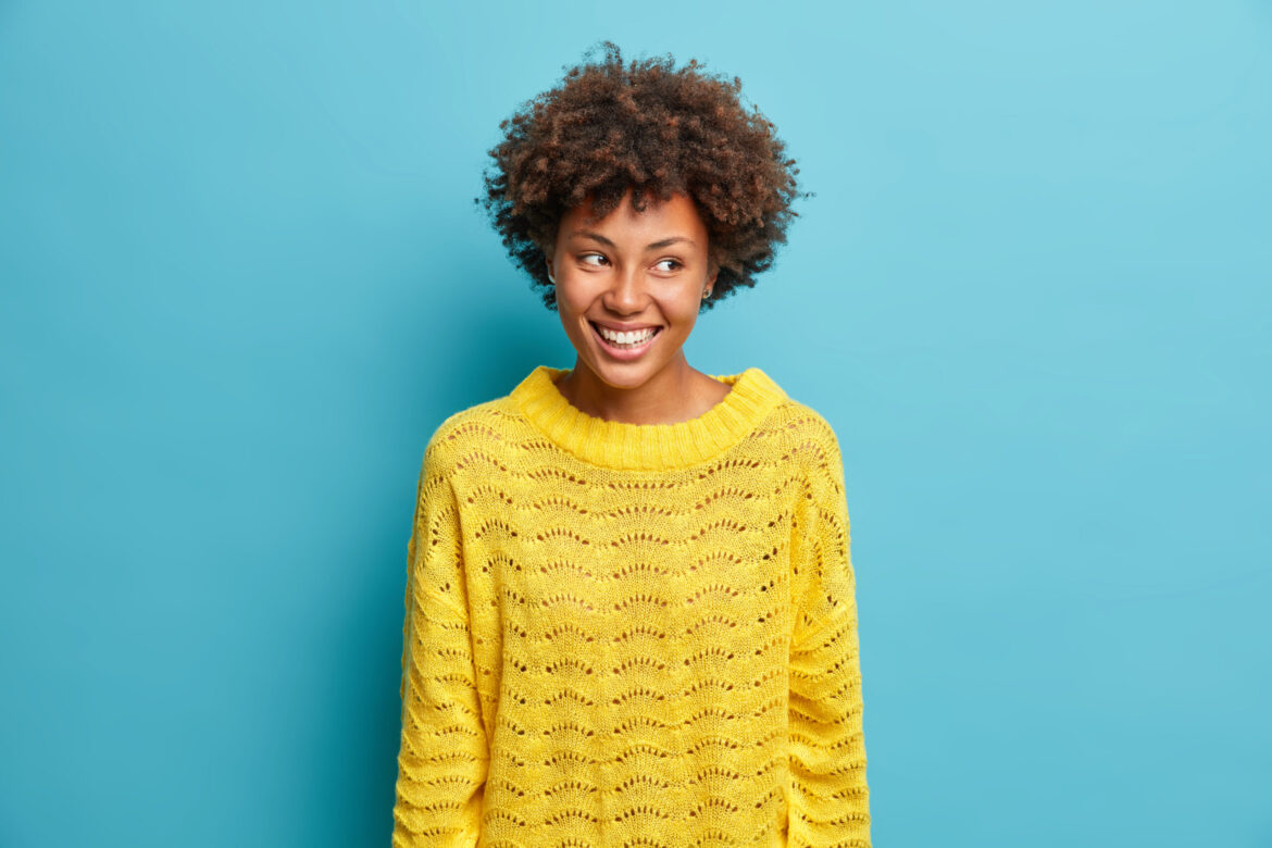Woman smiling against blue background